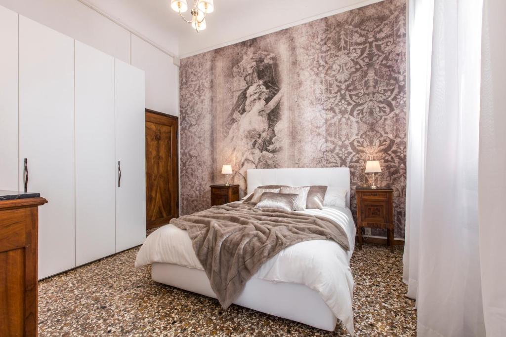 威尼斯Rialto Design Boutique Apartment R&R的卧室配有一张白色床,墙上挂有绘画作品