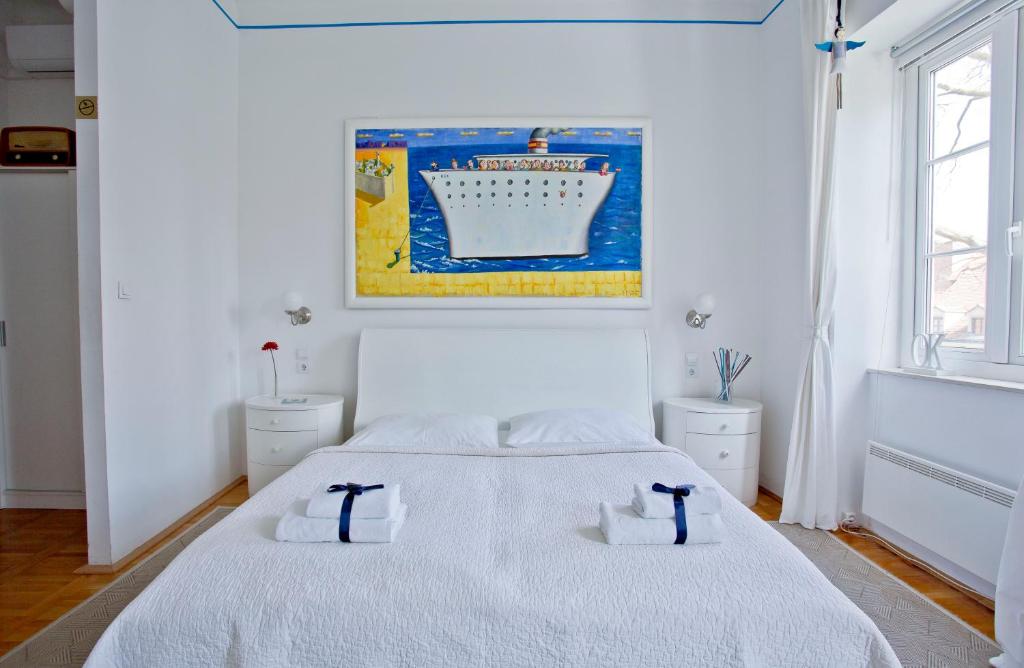 萨格勒布萨格勒布17号酒店的白色卧室配有带2条毛巾的床