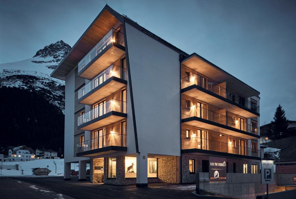 加尔蒂Silva Peak Residences Galtür - Paznaun - inkl Premium Silvretta Card的山前灯火通明的建筑