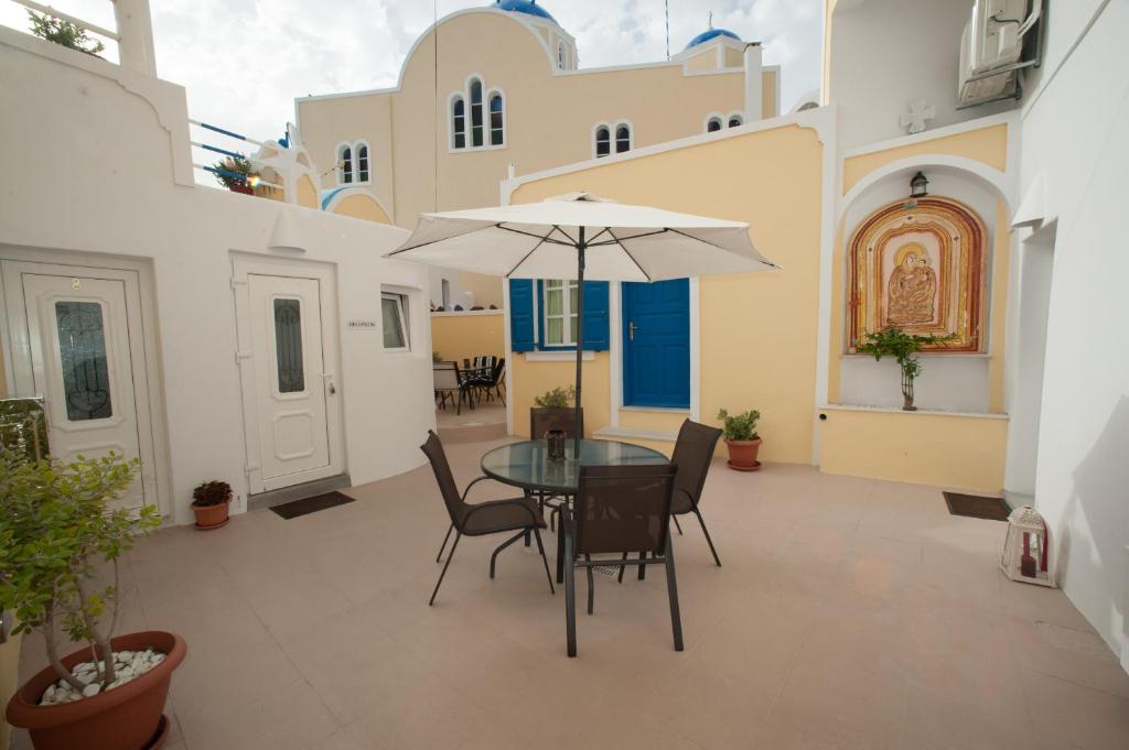 费拉拉夫特里斯传统客房酒店的庭院配有桌椅和遮阳伞。