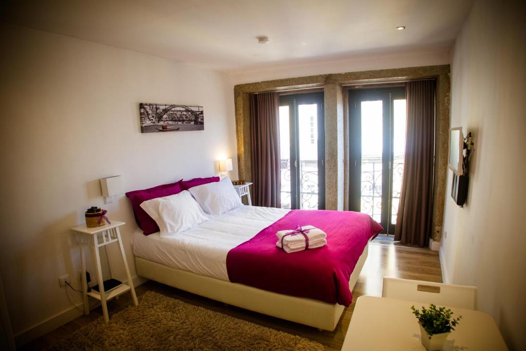 波尔图Historical Porto Studios的一间卧室配有一张带粉色毯子的大床
