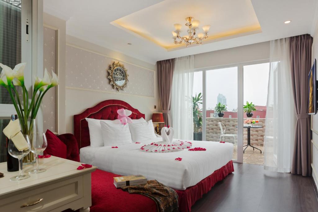 河内Luxury Old Quarter Hotel & Gym的一间卧室配有一张白色大床和红色床头板