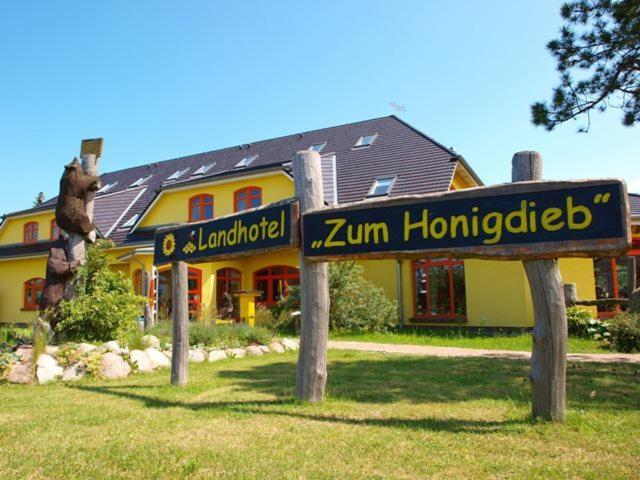 里布尼茨达姆加滕Landhotel zum Honigdieb的前面有标志的房子
