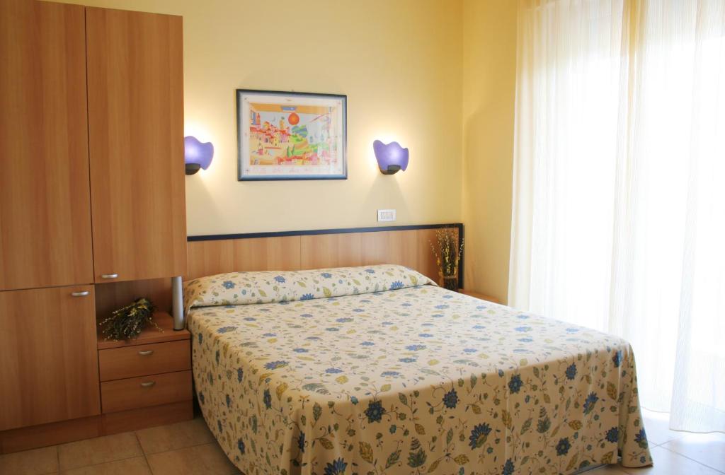 朱利亚诺瓦蓝色海洋公寓式酒店的一间卧室设有一张床和一个窗口