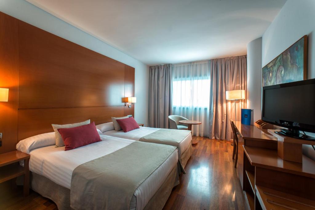 穆尔西亚Allegro Murcia Azarbe的酒店客房设有两张床和一台平面电视。