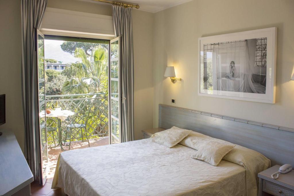 马尔米堡米尼翁酒店的一间卧室设有一张床和一个大窗户