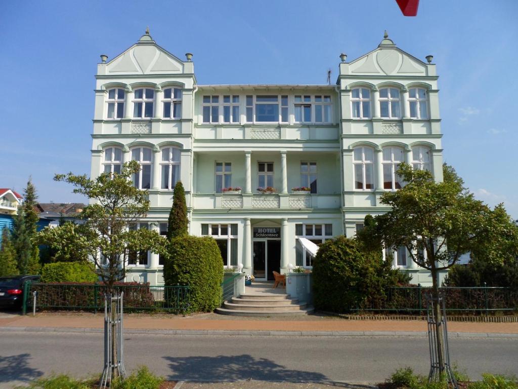 赛巴特班森施伦斯贾尼酒店的街道上一座白色的大建筑
