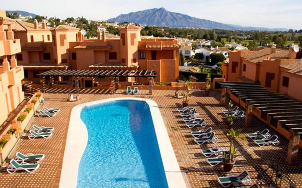 EsteponaApartment Design Marbella的享有度假村游泳池的景致