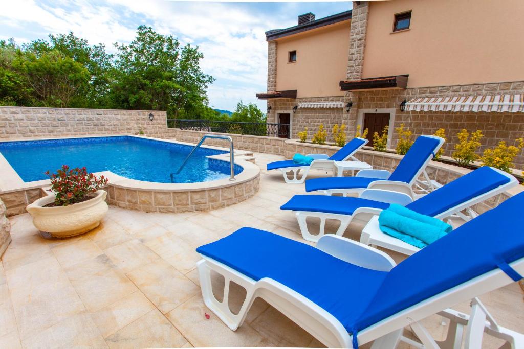斯韦蒂·斯特凡Rosmarino的一个带蓝色椅子的庭院和一个游泳池