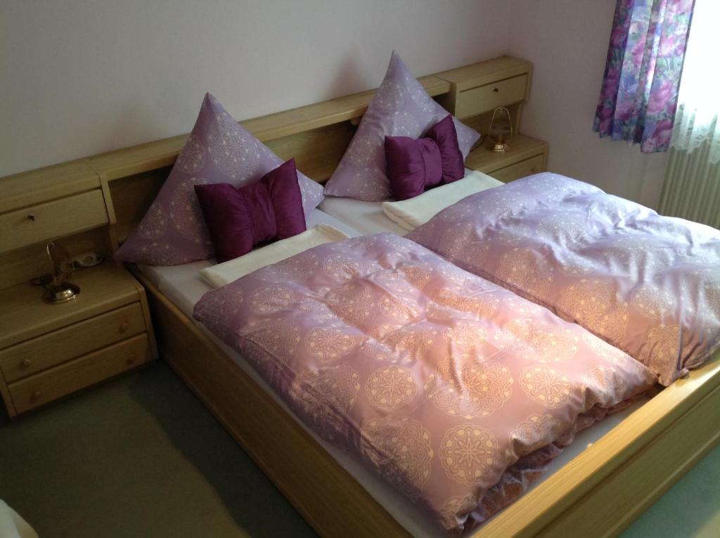 柯尼希斯湖畔舍瑙菲林公寓的两张带粉色和紫色枕头的床