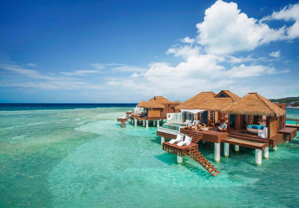 蒙特哥贝Sandals Royal Caribbean All Inclusive Resort & Private Island - Couples Only的水中设有木制小屋的岛屿