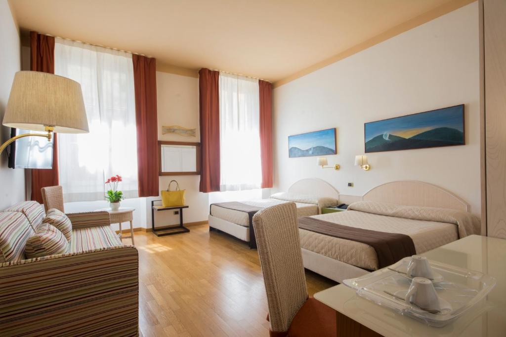 锡耶纳帕拉迪索广场住宿旅馆的酒店客房带两张床和一个客厅