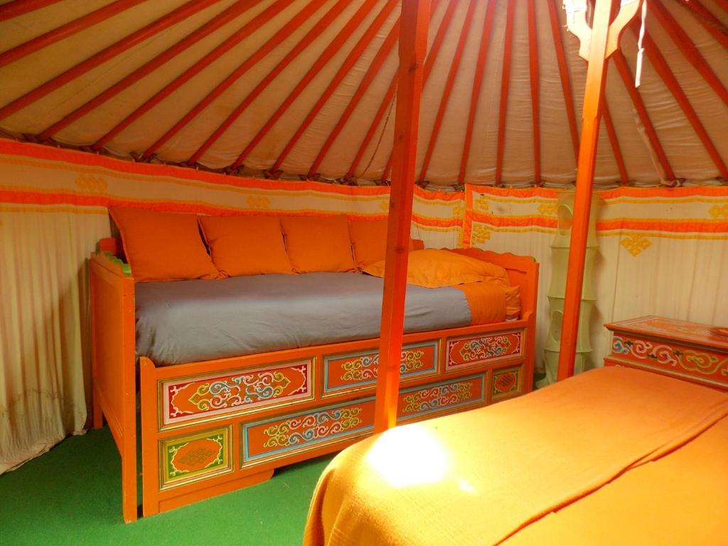 HurielYourte mongole的蒙古包内一间卧室,配有两张床