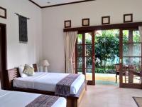 Ubud Lestari Bungalows客房内的一张或多张床位