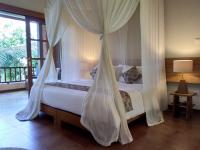 Ubud Lestari Bungalows客房内的一张或多张床位