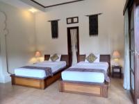 Ubud Lestari Bungalows客房内的一张或多张床位