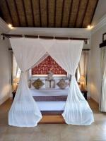 Ubud Lestari Bungalows客房内的一张或多张床位