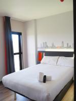 略夫雷加特河畔奥斯皮塔莱特easyHotel Barcelona Fira的卧室里有一张白色的大床，床边有一扇窗户