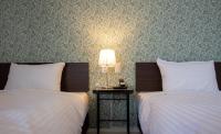 Cozy Inn OTARU客房内的一张或多张床位
