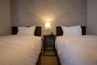Cozy Inn OTARU客房内的一张或多张床位