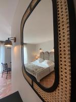 Hôtel l'Arena客房内的一张或多张床位