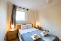 伦敦Royal London Apartments的一间卧室，床上有两条毛巾