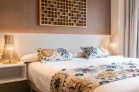 Apartamentos Core Suites Valencia客房内的一张或多张床位