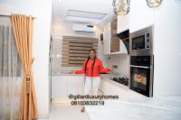 贝宁城Gillant Luxury Homes的站在房子厨房中的女人