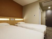 Plum Hotel客房内的一张或多张床位
