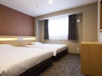 Plum Hotel客房内的一张或多张床位