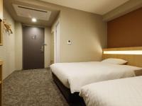 Plum Hotel客房内的一张或多张床位
