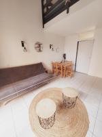 乐巴凯尔斯Villa 6 couchages spa privatif, accès direct mer, piscine的客厅配有两张桌子和一张沙发