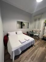 米兰Fiori 3 Apartment的卧室里有一张白色的大床和一张桌子