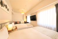 QuintessaHotel KagoshimaTenmonkan Relax&Sleep客房内的一张或多张床位