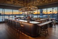 巴尔的摩Canopy By Hilton Baltimore Harbor Point - Newly Built的餐厅内的酒吧享有水景