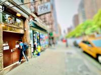 纽约New York Spirit Retreats HOSTEL的走在街上的男人穿过商店