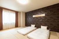 Tabino Hotel lit Matsumoto Milky white Onsen客房内的一张或多张床位