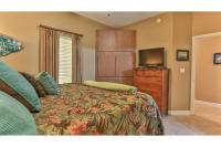 德斯坦Beach Resort 507 - Great Views Beautiful Decor Zero Entry Pool的一间带床和平板电视的卧室