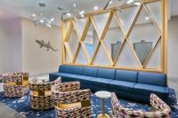 奥兰多Hyatt House Orlando Airport的一间配备有蓝色沙发和椅子的等候室