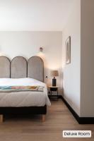Hôtel l'Arena客房内的一张或多张床位