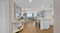 德斯坦St Maarten 907 a Newly Renovated Luxury Beach Front 3 Bedroom 9th Floor Private Elevator的厨房、带白色橱柜的客厅和用餐室