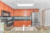 默特尔比奇Stunning Double Balcony- Oceanfront 2 Bedroom, 2 Bath- Anderson Ocean Club 905的配有木质橱柜和不锈钢冰箱的厨房