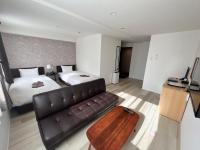 Cozy Inn OTARU客房内的一张或多张床位