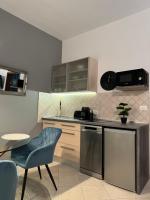 普拉Leone apartments with free parking的厨房配有蓝色椅子和桌子
