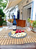 塞维利亚Típico y pintoresco patio de vecinos, con encanto的桌子上放有一瓶葡萄酒和奶酪,配以酒杯