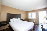 罗内特公园Budget Inn by 101 Bus from Downtown的卧室里有一张白色的大床和一扇窗户
