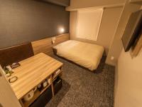 Super Hotel Sendaieki Higashiguchi Tennenonsen客房内的一张或多张床位