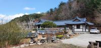 江陵市Gangneung Wangsangoal Hanok Pension的一栋建筑前停着一辆车