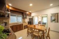 清迈Baan San sook Pool Villa at Nimman的配有木桌和椅子的厨房