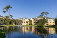默特尔比奇Sheraton Broadway Resort Villas的带有湖泊和建筑的度假村景观